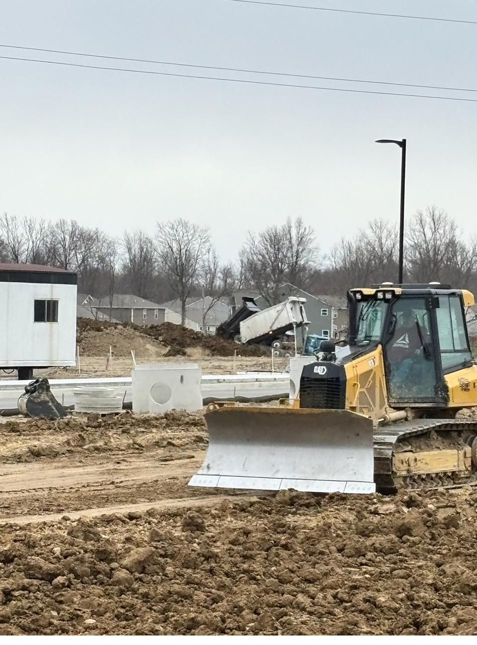 Dozer with GPS blade grading a building pad